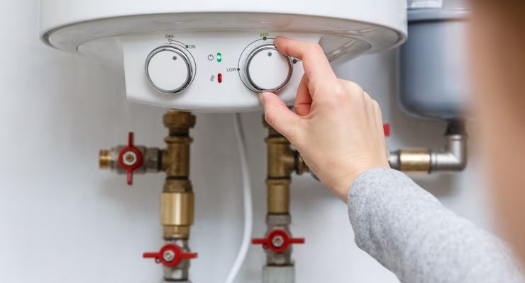 imgi_183_female-hand-puts-thermostat-electric-water-heater-boiler-economy-mode-